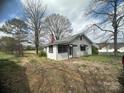 Quaint home featuring a chimney, shaded windows, and a large yard at 4349 Roberta Rd, Concord, NC 28027