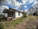 Home's side view showing a cozy porch and brick foundation details at 4349 Roberta Rd, Concord, NC 28027