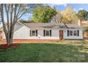 Beautiful exterior of a home with a manicured lawn, flowerbeds and mature trees in the front yard at 4515 Country Meadows Dr, Gastonia, NC 28056