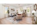 Bright and airy living room with modern decor, stylish furniture, and large windows at 5108 Potter Rd, Matthews, NC 28104