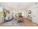 Spacious living room with neutral tones, elegant furnishings, and ample natural light at 5108 Potter Rd, Matthews, NC 28104