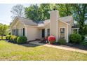 Charming single-story home featuring a well-manicured lawn and tasteful landscaping with black shutters at 602 S Church St, Lowell, NC 28098