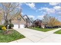 A beautiful home with a well-manicured lawn, a spacious driveway, and mature trees at 717 Barossa Valley Nw Dr, Concord, NC 28027