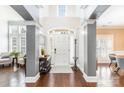 Bright foyer with soaring ceilings, dark wood floors, neutral walls, and an arched front door with sidelights at 717 Barossa Valley Nw Dr, Concord, NC 28027
