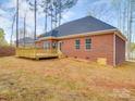 Image displaying a brick home with a wooden deck and a walkout basement entrance at 725 Granna Ln, Lancaster, SC 29720