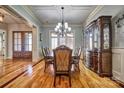 Formal dining room with beautiful hardwood floors, chandelier, and sophisticated decor at 820 Cooks Cove Rdg, Lake Wylie, SC 29710