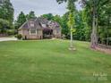 Beautiful brick home with lush lawn, mature trees, and a well-maintained landscape at 820 Cooks Cove Rdg, Lake Wylie, SC 29710
