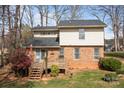 Expansive backyard featuring a wooden deck, lush landscaping, and mature trees on a well-kept lawn at 8260 Graham Rd, Denver, NC 28037