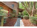 Charming log home featuring a stone walkway to the covered front porch at 1007 Mistywood Ln, Concord, NC 28027