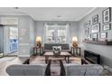 Comfortable living room with gray sofa, stylish lamps, neutral rug, modern décor and an inviting atmosphere at 1016 Council Fire Cir, Indian Trail, NC 28079