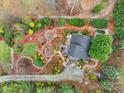 Stunning aerial view of a home featuring meticulous landscaping with winding stone pathways at 106 Brookwood Ln, Taylorsville, NC 28681