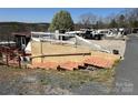 View of a home with camper parked next to a multi-vehicle parking area at 108 Robin Ln, New London, NC 28127