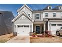 Charming townhome with a one-car garage and inviting front porch, enhancing curb appeal at 11120 Pagebrook Ln, Charlotte, NC 28214