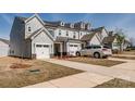 View of newly constructed townhomes with attached garages and well-manicured lawns on a sunny day at 11120 Pagebrook Ln, Charlotte, NC 28214