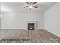 Spacious living room with a traditional fireplace and stylish flooring at 2019 Mcdonald Dr, Charlotte, NC 28216