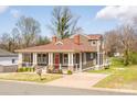 Beautiful two-story home with a welcoming porch, mature trees, and a well-maintained lawn at 232 Cromer St, Charlotte, NC 28208