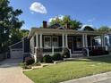Charming single Gathering home with a welcoming front porch, white pillars, stone accents, and well-manicured lawn at 232 Cromer St, Charlotte, NC 28208
