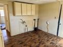 Kitchen with hardwood floors and upper cabinets awaiting renovation at 2609 E Greenbriar Rd, Statesville, NC 28625