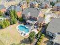Aerial shot showcases a private backyard with a large pool, patio and manicured landscaping at 2616 Creek Manor Dr, Waxhaw, NC 28173