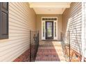 Inviting front porch with brick steps, decorative railing, and a stylish front door with glass panels at 282 W Shiloh Unity Rd, Lancaster, SC 29720