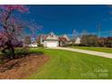 Attractive two-story house with lush green lawn, long driveway, and blossoming tree in the yard at 282 W Shiloh Unity Rd, Lancaster, SC 29720