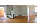 Spacious living room showcasing hardwood floors, decorative molding, and an inviting entrance foyer at 3238 Pinehurst Pl # B, Charlotte, NC 28209