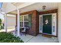 Charming front porch with brick accents, a cozy seating area, and a welcoming entrance to the home at 3908 Parkers Ferry Rd, Fort Mill, SC 29715