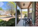 Charming covered front porch featuring brick accents, stylish seating, and a welcoming entrance at 3908 Parkers Ferry Rd, Fort Mill, SC 29715