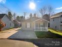 Charming home with a well-manicured lawn, and an inviting front porch, perfect for relaxation and curb appeal at 4 Short St, Belmont, NC 28012
