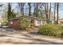 Well-maintained one-story home featuring a brick side and a spacious driveway with mature landscaping at 5215 Milford Rd, Charlotte, NC 28210