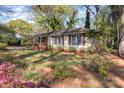 Lovely front yard with mature flowering plants and a well-maintained lawn framing a quaint home at 5215 Milford Rd, Charlotte, NC 28210
