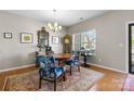 Classic dining room with hardwood floors, a large window and elegant furnishings including a round wooden table at 5827 Eleanor Rigby Rd, Charlotte, NC 28278