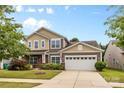 Charming two-story home with a well-manicured lawn, attached two-car garage, and beautiful curb appeal at 5827 Eleanor Rigby Rd, Charlotte, NC 28278