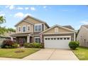 Charming two-story home with a well-manicured lawn, attached two-car garage, and beautiful curb appeal at 5827 Eleanor Rigby Rd, Charlotte, NC 28278