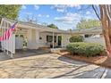 Inviting front porch with rocking chairs, a brick facade, and a covered entrance at 821 Fairbanks Rd, Charlotte, NC 28210