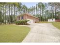 Well-maintained brick home with long driveway, two car garage and manicured landscaping at 8801 Oldenburg Dr, Mount Pleasant, NC 28124