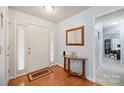 Bright foyer featuring hardwood floors, a decorative table, and a welcoming atmosphere at 8801 Oldenburg Dr, Mount Pleasant, NC 28124