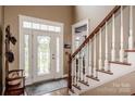 Inviting foyer with hardwood floors, staircase, and a stained-glass front door at 1027 Brookline Dr, Huntersville, NC 28078