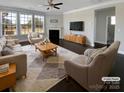 Staged living room boasts a fireplace, three large windows, and plenty of space for relaxing and entertaining at 111 Canada Dr, Statesville, NC 28677