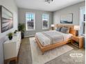 Staged bedroom featuring soft carpet, neutral walls, and a large windows for natural light at 111 Canada Dr, Statesville, NC 28677