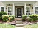 Inviting front porch with decorative columns and manicured landscaping at 13127 Centennial Commons Pkwy, Huntersville, NC 28078
