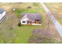 Aerial view of a house with a gravel driveway and expansive green lawn, surrounded by mature trees at 3001 Austin Chaney Rd, Monroe, NC 28110