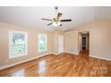 Bright living room with hardwood floors, neutral walls, ceiling fan, and natural light from two windows at 3001 Austin Chaney Rd, Monroe, NC 28110