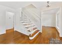 Bright foyer with hardwood floors and a staircase with decorative iron railings at 5114 Glenbrier Dr, Charlotte, NC 28212