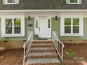 Inviting front entrance with brick steps, white railings, and a freshly painted front door at 5114 Glenbrier Dr, Charlotte, NC 28212