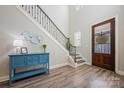Bright foyer with hardwood floors, staircase with iron spindles, and stylish decor at 6398 Chimney Bluff Rd, Lancaster, SC 29720