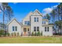 Charming two-story home with a welcoming front porch, well-manicured lawn, and classic white siding at 6398 Chimney Bluff Rd, Lancaster, SC 29720