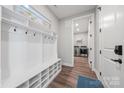 Well-organized mud room with coat hooks, storage bench, and easy access to laundry room and exterior at 6398 Chimney Bluff Rd, Lancaster, SC 29720