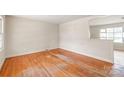 Bright living room featuring hardwood floors and natural light at 7207 Idlewild Rd, Charlotte, NC 28212
