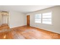 Inviting living room with hardwood floors and a front door entrance at 7207 Idlewild Rd, Charlotte, NC 28212